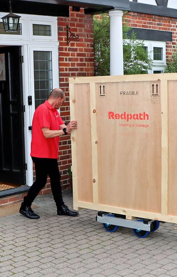 Redpath crew handling a crate outside a house in London
