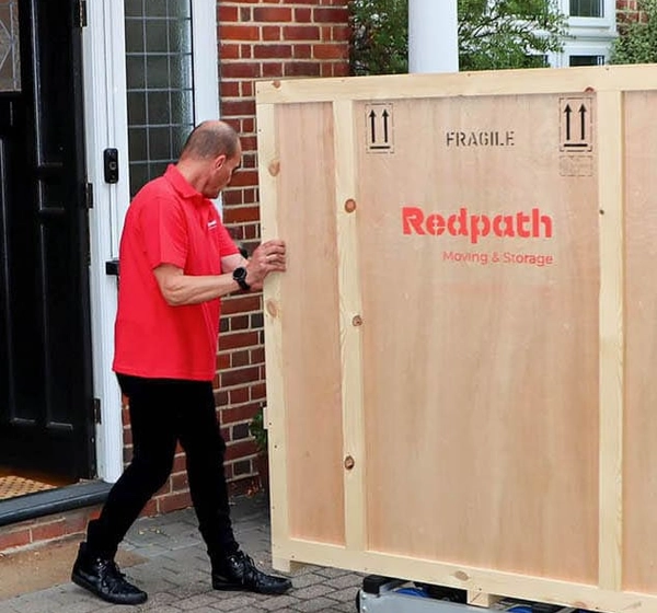 Redpath crew handling a crate outside a house in London