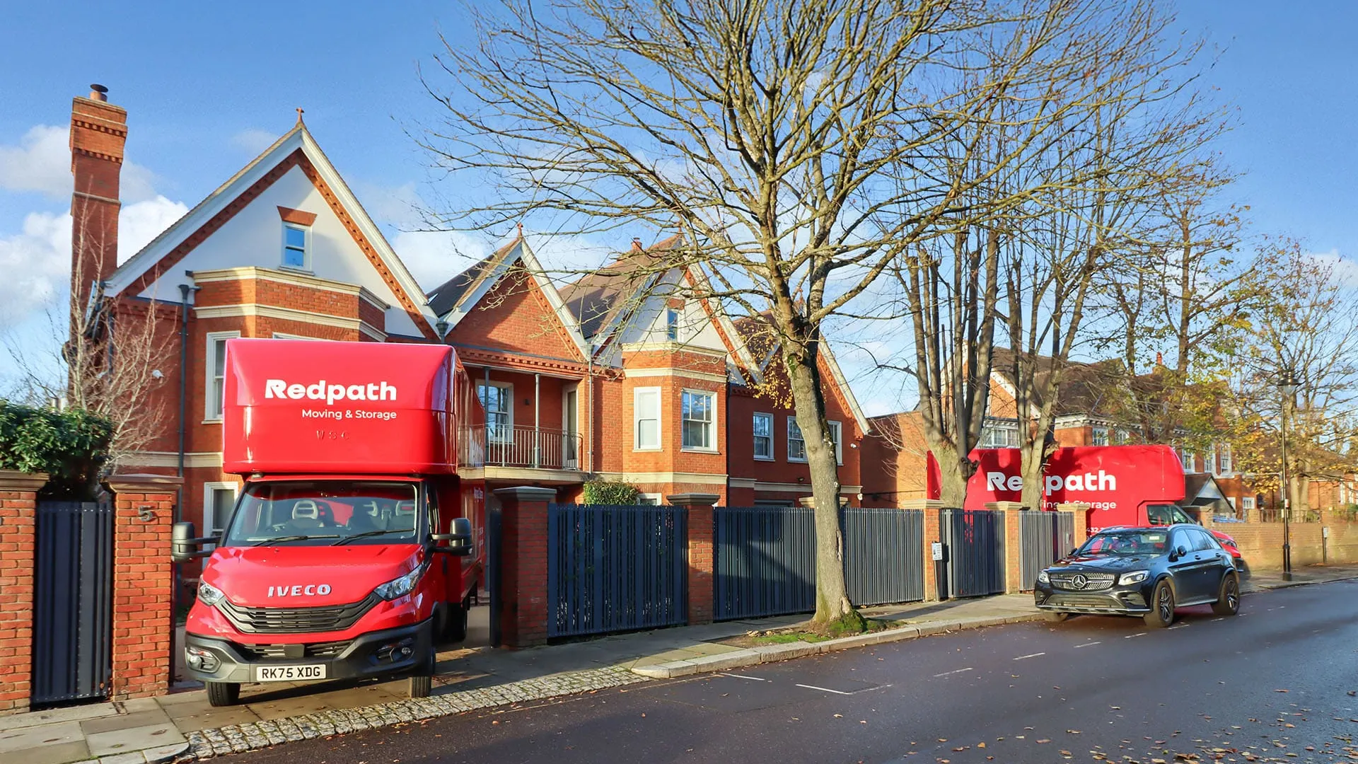 Redpath Moving & Storage trucks ready outside a London home