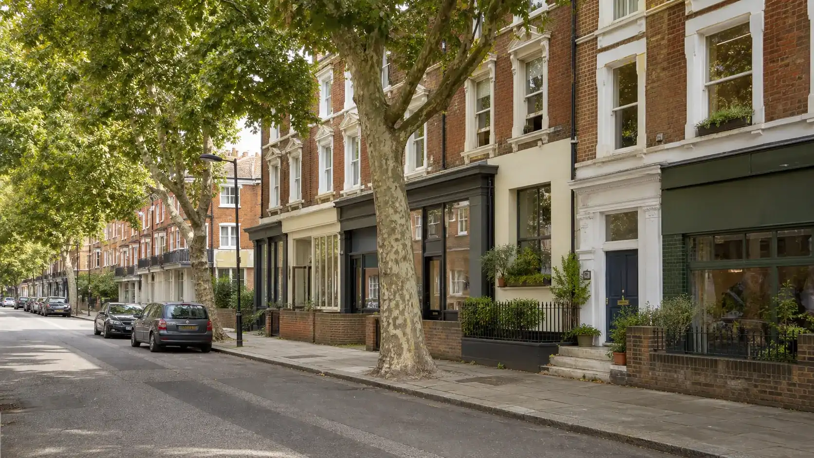 Tree-lined Victorian homes on a residential street in Kentish Town, London