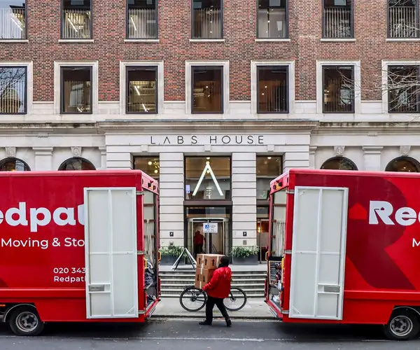 Redpath crew carefully loading a storage container in a North London home