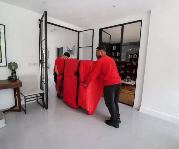 Redpath piano moving specialists using protective equipment to lift and secure a grand piano