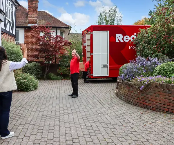 Redpath moving crew completing a settling-in service and saying goodbye to a happy client in London